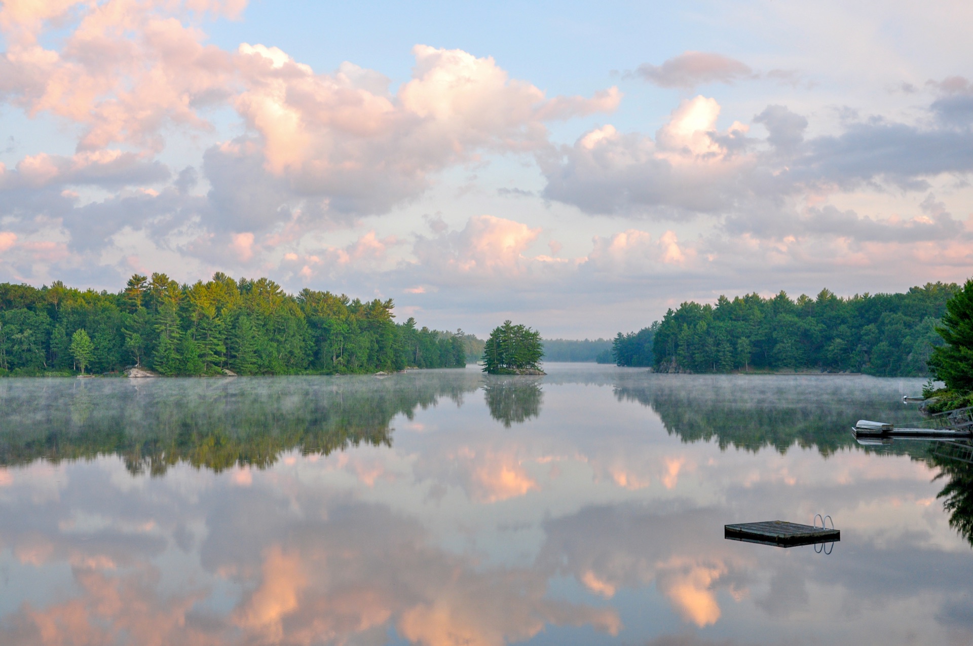 Mist rising over a calm lake at dawn in the City of Kawartha Lakes