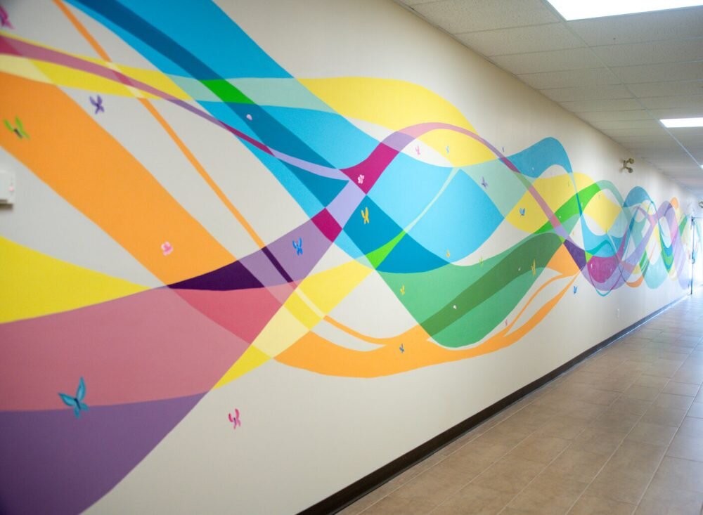 Local artist paints a meaningful mural for Chimo Youth & Family Services