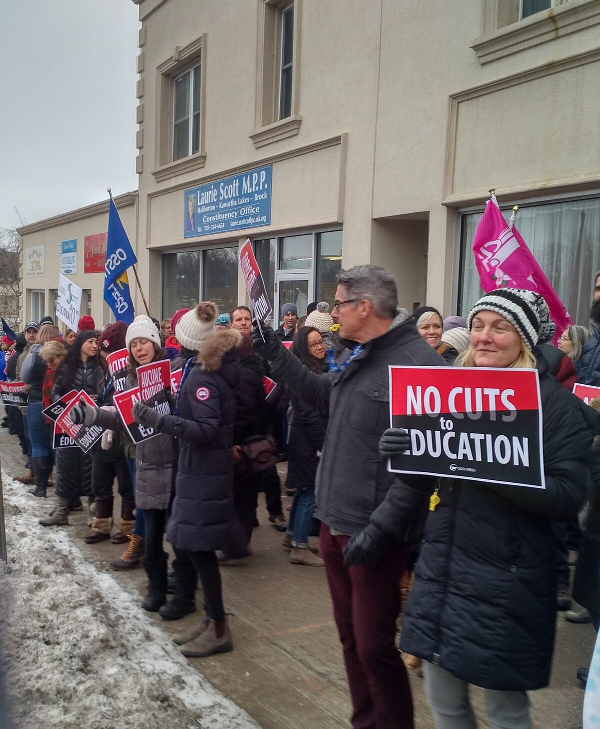 Dozens protest against education cuts in front of Laurie Scott's office