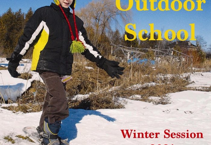 Child on snow shoes smiles and walks towards a camera. On the left of him the poster reads "Outdoor School" and "Winter Session 2021"