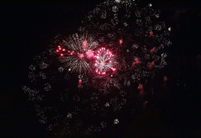 Red fireworks against a black sky